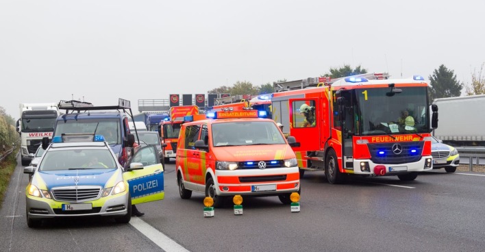 Polizei und Feuerwehr sichern Unfallstelle auf der A3 bei Passau, während nach einem grauen Porsche 911 gefahndet wird