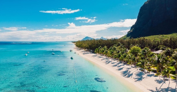 Traumstrand auf Mauritius mit türkisblauem Meer und Palmen.