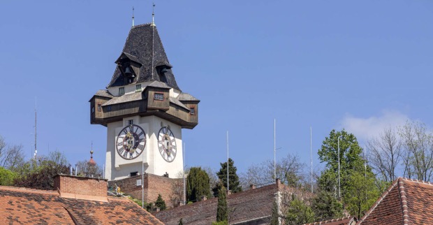 Der Grazer Uhrturm vor blauem Himmel