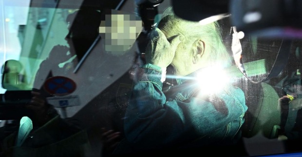 Josef Fritzl verdeckt im Auto mit der Hand sein Gesicht.