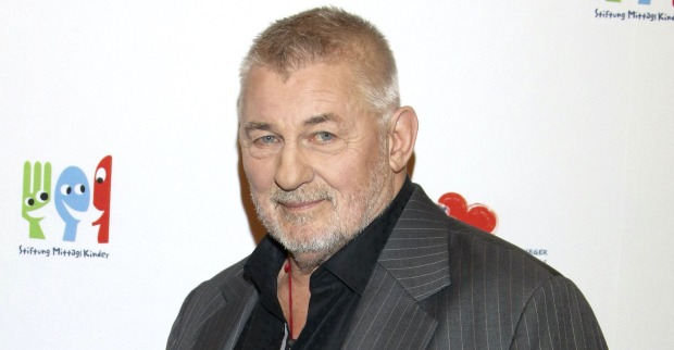 Heinz Hoenig mit einem grauen Anzug und einem schwarzen Hemd bei einem Event.