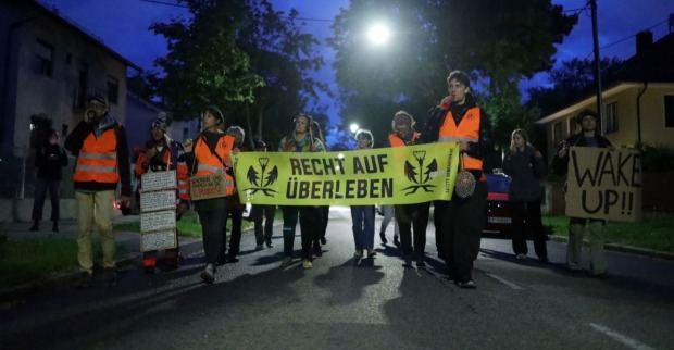 Klimaaktivisten marschieren brüllend durch Wiens Straßen.