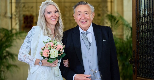 Richard Lugner und Simone Reiländer beim Standesamt in einem weißen Kleid. Lugner trägt einen Smoking.