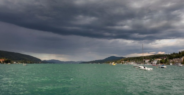 Ein Gewitter zieht über einem See auf.