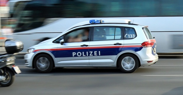 Ein Polizeiauto fährt auf einen stark befahrenen Straße zu einem Einsatz.