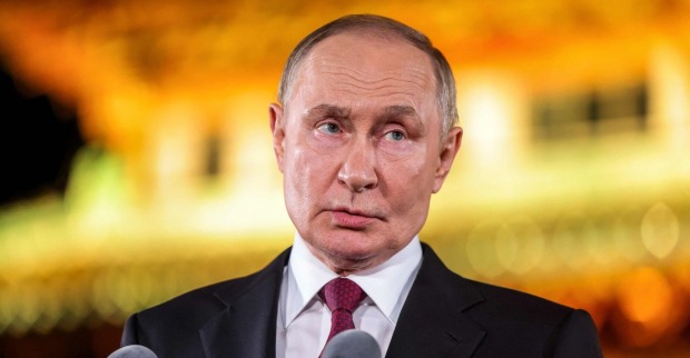 Wladimir Putin spricht bei einer Pressekonferenz in Peking, im Hintergrund unscharf beleuchtete Szenerie.