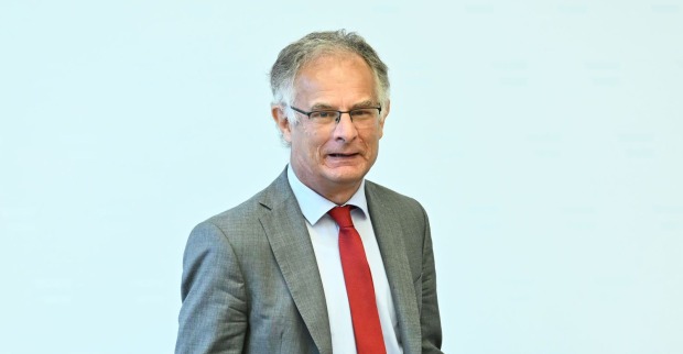 Finanzminister Marterbauer bei Pressekonferenz in Wien, im grauen Anzug mit roter Krawatte, spricht über geplantes Doppelbudget und seinen Rückzug nach der Legislaturperiode.