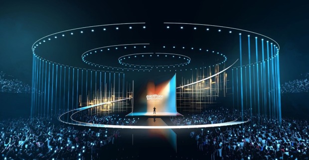Futuristische Bühne des Eurovision Song Contest 2026 in Wien mit leuchtenden Lichtkreisen, LED-Effekten und großem Publikum in einer modernen Arena.