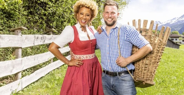 Arabella Kiesbauer mit einem „Bauer sucht Frau“-Kandidaten auf einer Wiese in Tirol bei der Präsentation der neuen Staffel von „Bauer sucht Frau“