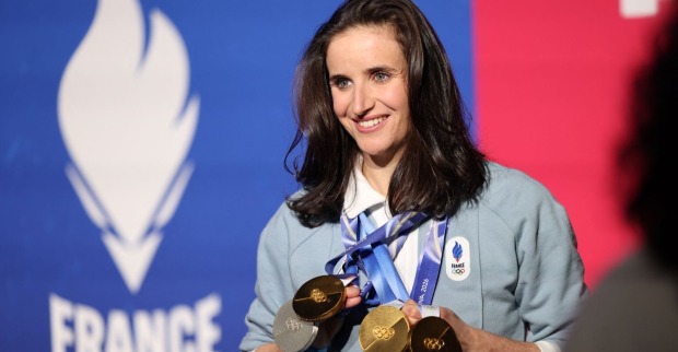 Julia Simon präsentiert ihre Medaillen bei den Olympischen Winterspielen 2026 nach dem Kreditkarten-Skandal und ihrer Kündigung durch die französische Zollbehörde.