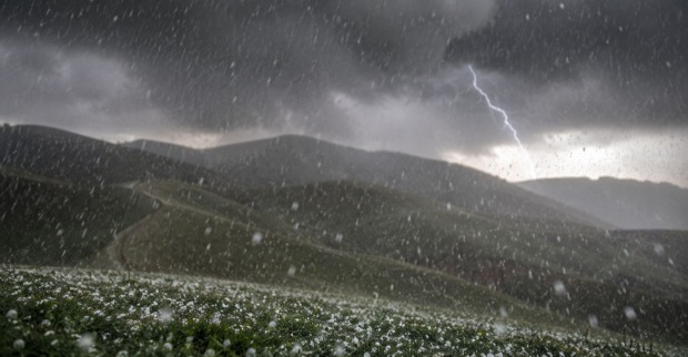 Gewitterwolken und fallende Hagelkörner als Themenbild für die Unwetter und Hagelwarnung in der Steiermark