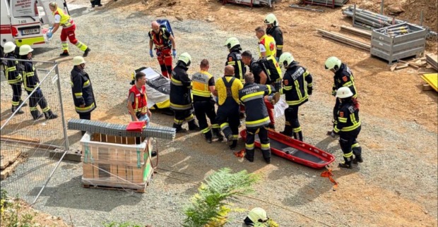 Feuerwehr und Rettungskräfte bei der Bergung eines Verletzten nach Baggerunfall auf Baustelle in Völkermarkt