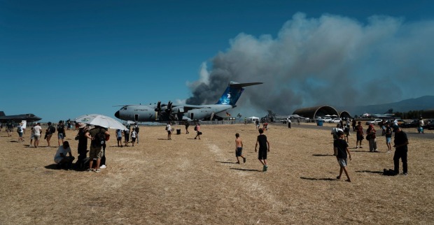 Dichte schwarze Rauchwolke steigt hinter Militärflugzeugen auf dem Flugplatz Tanagra auf