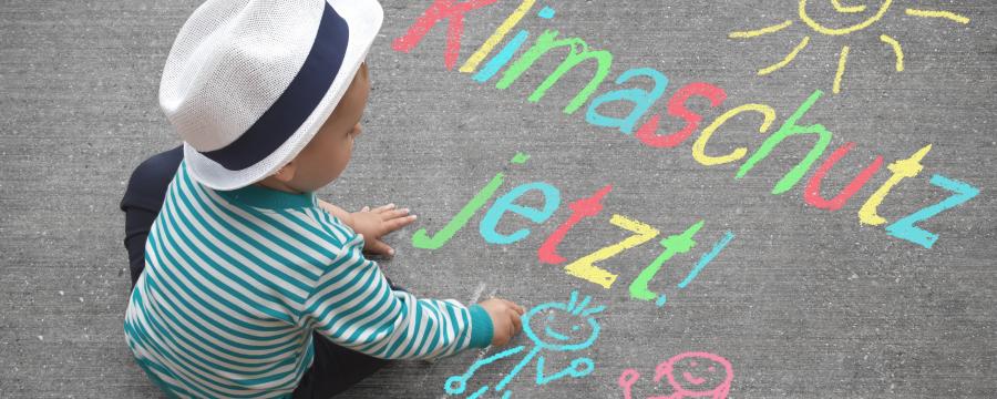 Kind sitzt auf der Straße mit Graffiti
