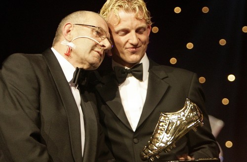 2006-08-28 00:00:00 HILVERSUM - Dirk Kuyt (r) en zijn vader (ook) Dirk Kuyt senior omhelzen elkaar op het podium nadat Dirk Kuyt de Gouden Schoen in ontvangst heeft genomen tijdens het Gala van de Voetballer van het Jaar maandagavond op het Mediapark in Hilversum. ANP PHOTO MAARTJE BLIJDENSTEIN