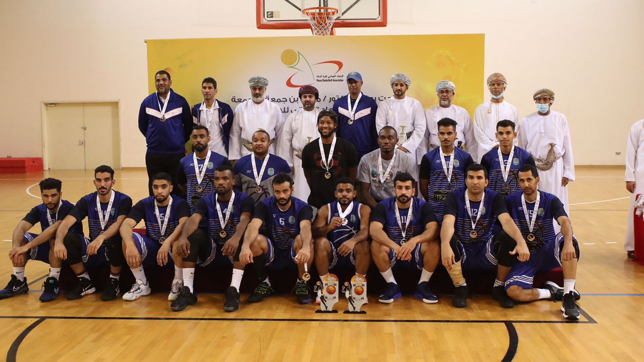 Okoth (in grey T-shirt poses for a photo with his new team as they finished second in the Oman league