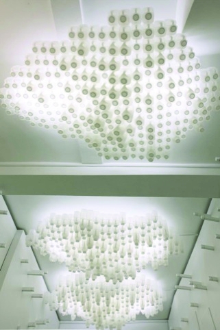 A ceiling light installation of milk bottles