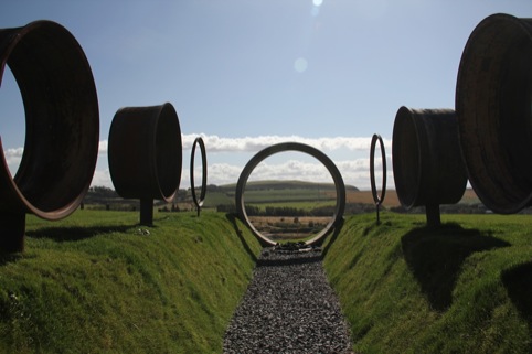 Charles Jencks, The Avenue of Doubles focuses through a sewer pipe on a volcano 375 million years old