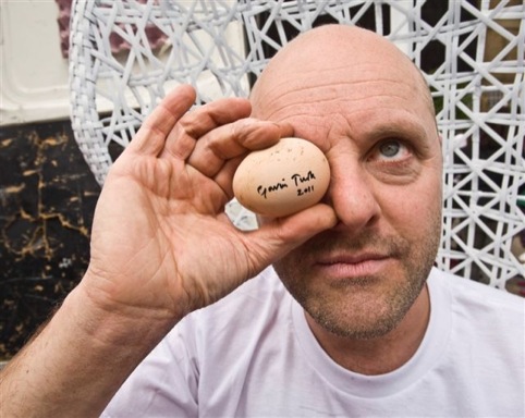 Gavin Turk holding an egg