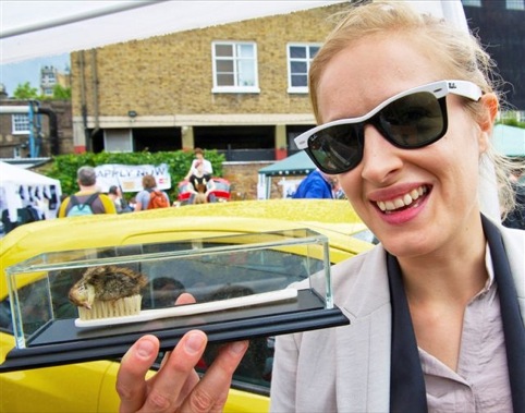 Polly Morgan laughing at a dead bird on a brush