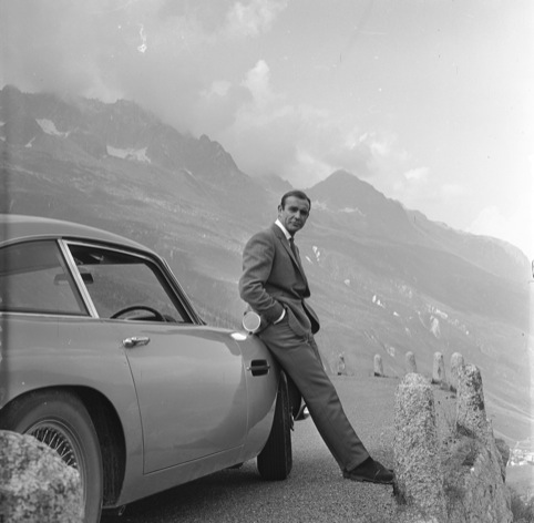 Sean Connory with Aston Martin DB5 in Goldfinger. 1964 Danjag, LLC and United Artists