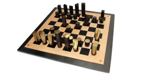 Chess Set, by Simon Hasan, 2012. Patinated brass, leather, hot-rolled steel plate.