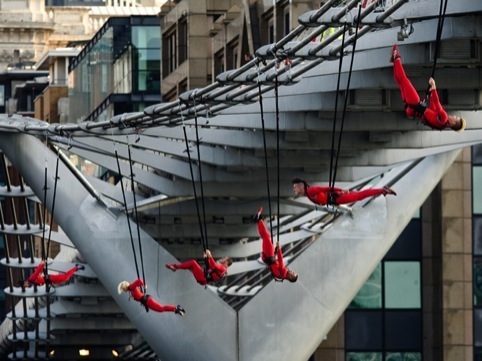 Dancers dangle from the Millennium Bridge