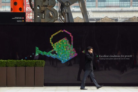 A watering can using the brand colours