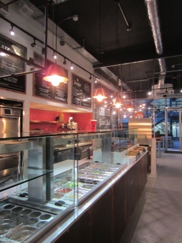 Copper clad counter and suspended lights. Hint of red visible in alcove