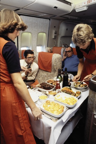 Hostesses serving a meal in a Boeing 747-257, 1978