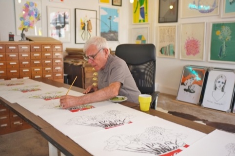 Bob gill hand colouring his Flowers print