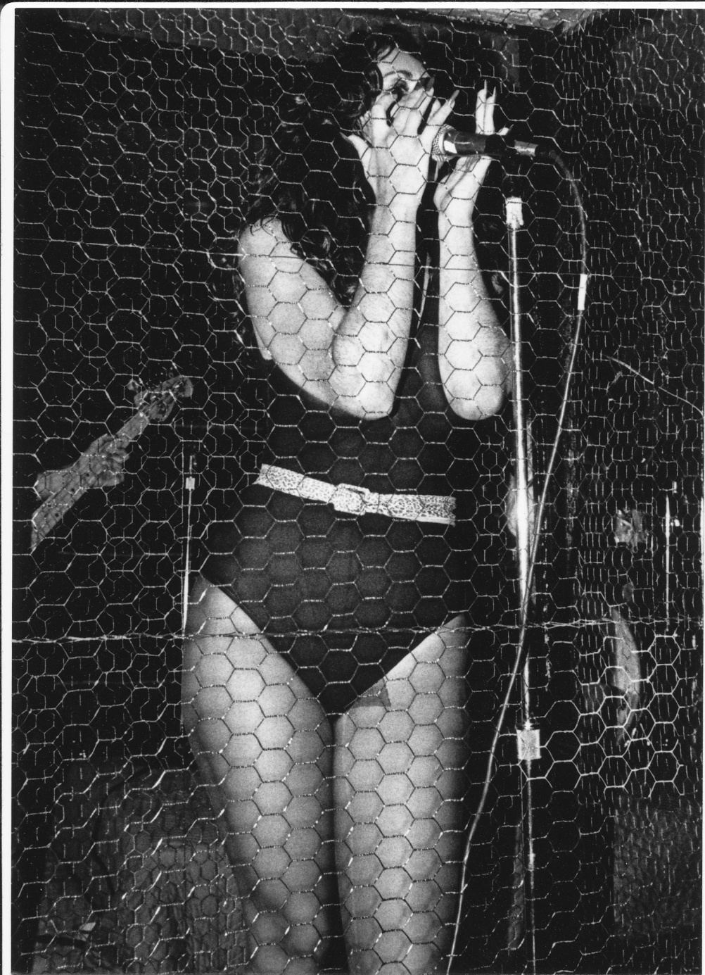 Lucy Lamode of Killer Pussy inside chicken wire cage at Mad Garden, 1981. By Neal “Doc” Holliday