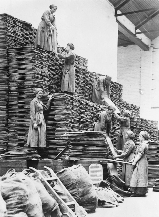 Women workers stacking oil cakes at an Oil and Cake factory, Lancashire, 1918