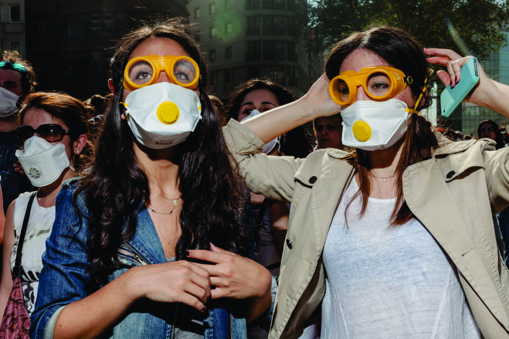 Women watch police fire tear gas canisters close to where they are standing. Gezi Park, Istanbul. By Guy Martin