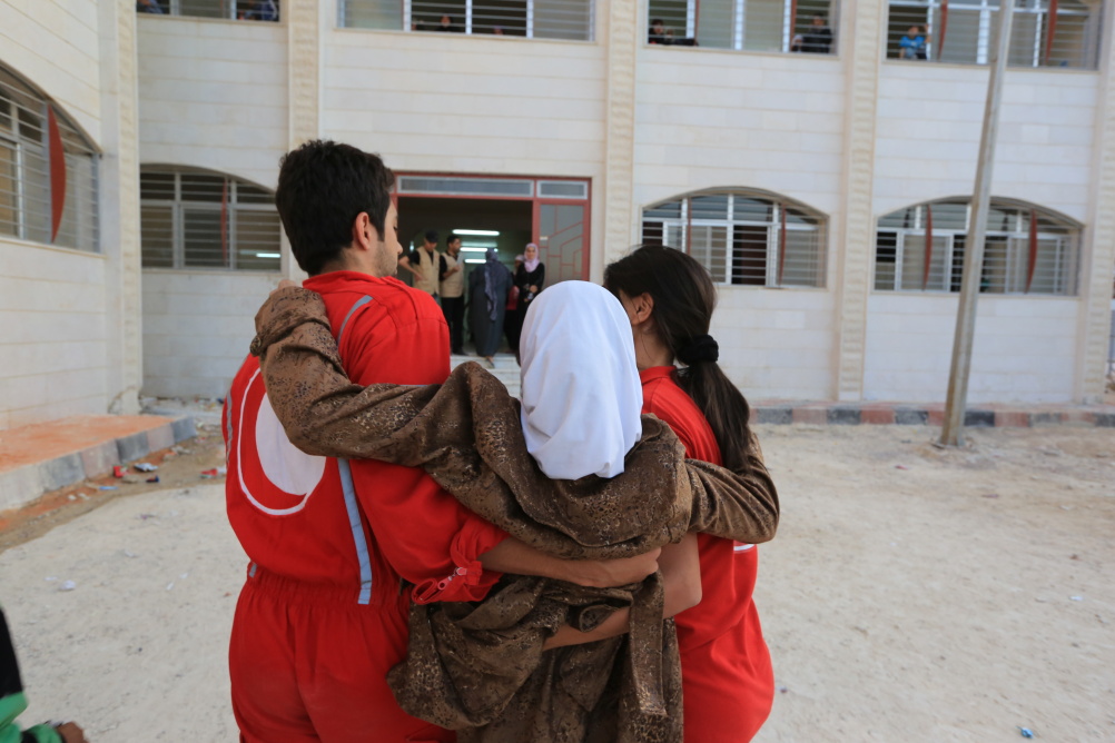 Syria: Humanity in Conflict at IWM North. Evacuation of 2,000 women, children and elderly men from Moaddamiyah, a besieged town in rural Damascus, 13 October 2013.