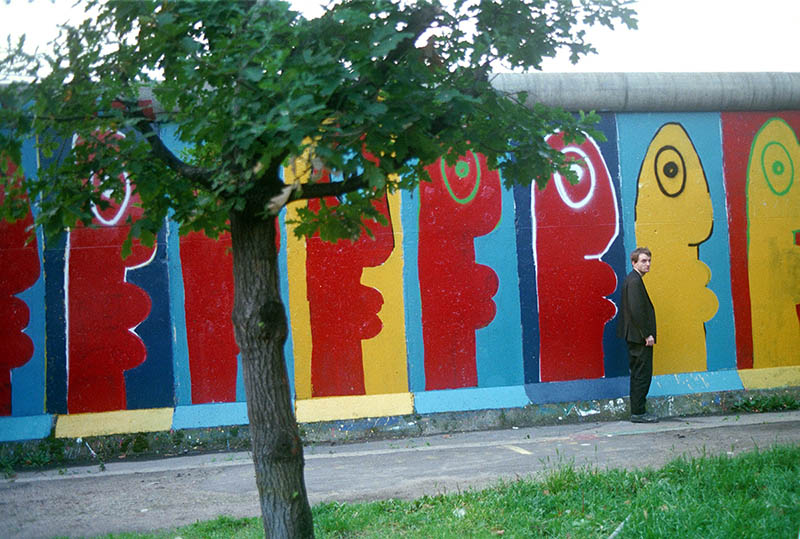 Thierry Noir standing by the Berlin Wall in the 1980s.