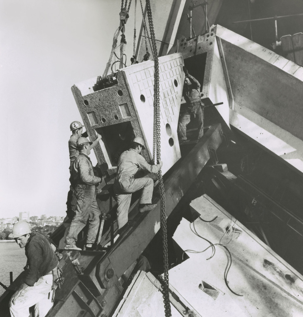 Installing a ridge beam segment on main shell, 1966