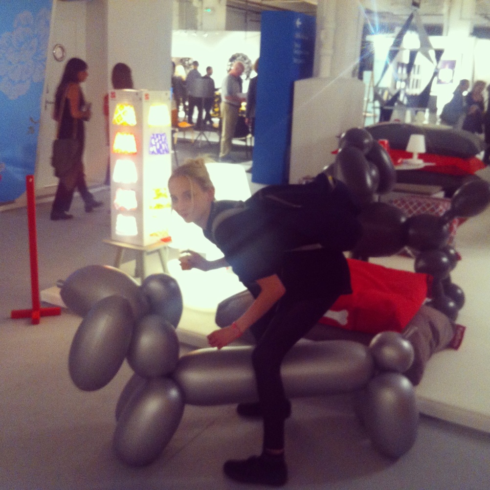 Astride a large inflatable Jeff Koons-esque dachshund