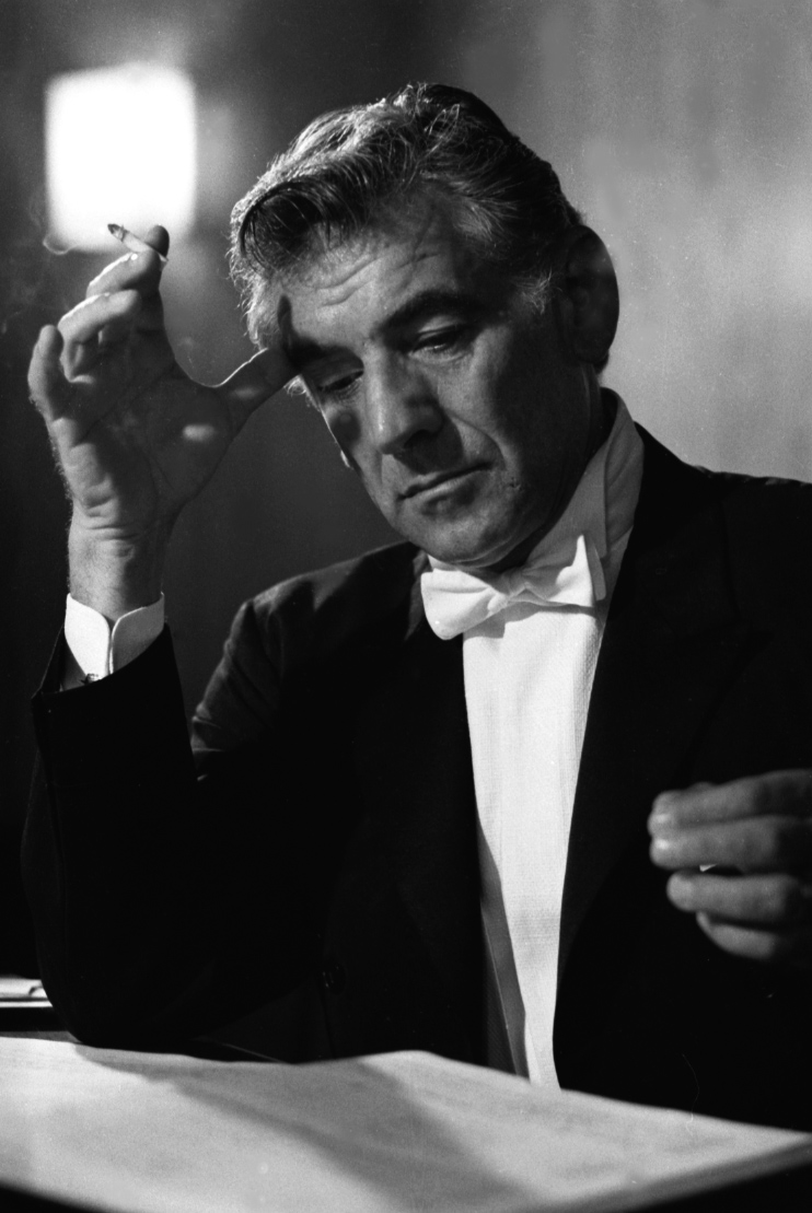 David Farrell, Leonard Bernstein looking over score in concert dress,1968.