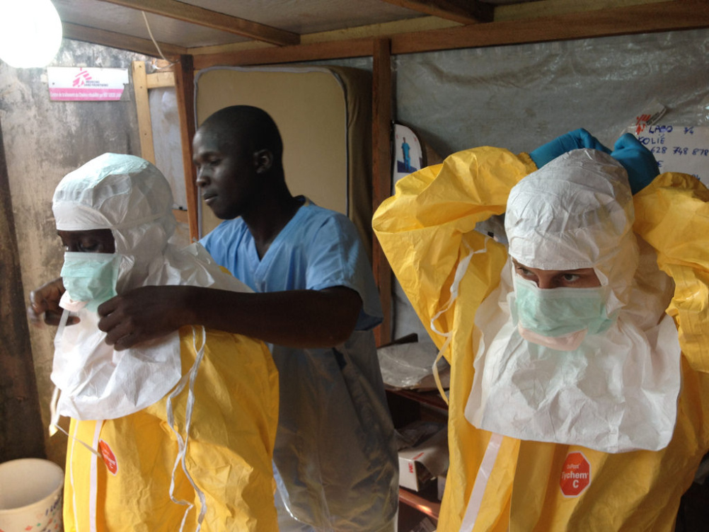 Healthcare workers in Guinea don protective suits as they prepare to tackle the Ebola epidemic