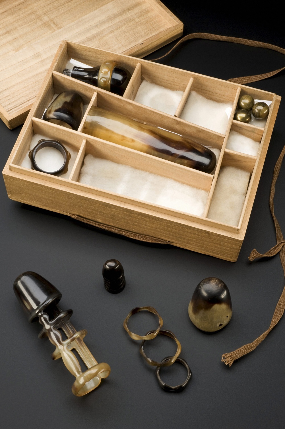 Collection of sexual aids, with instructions, in wooden box