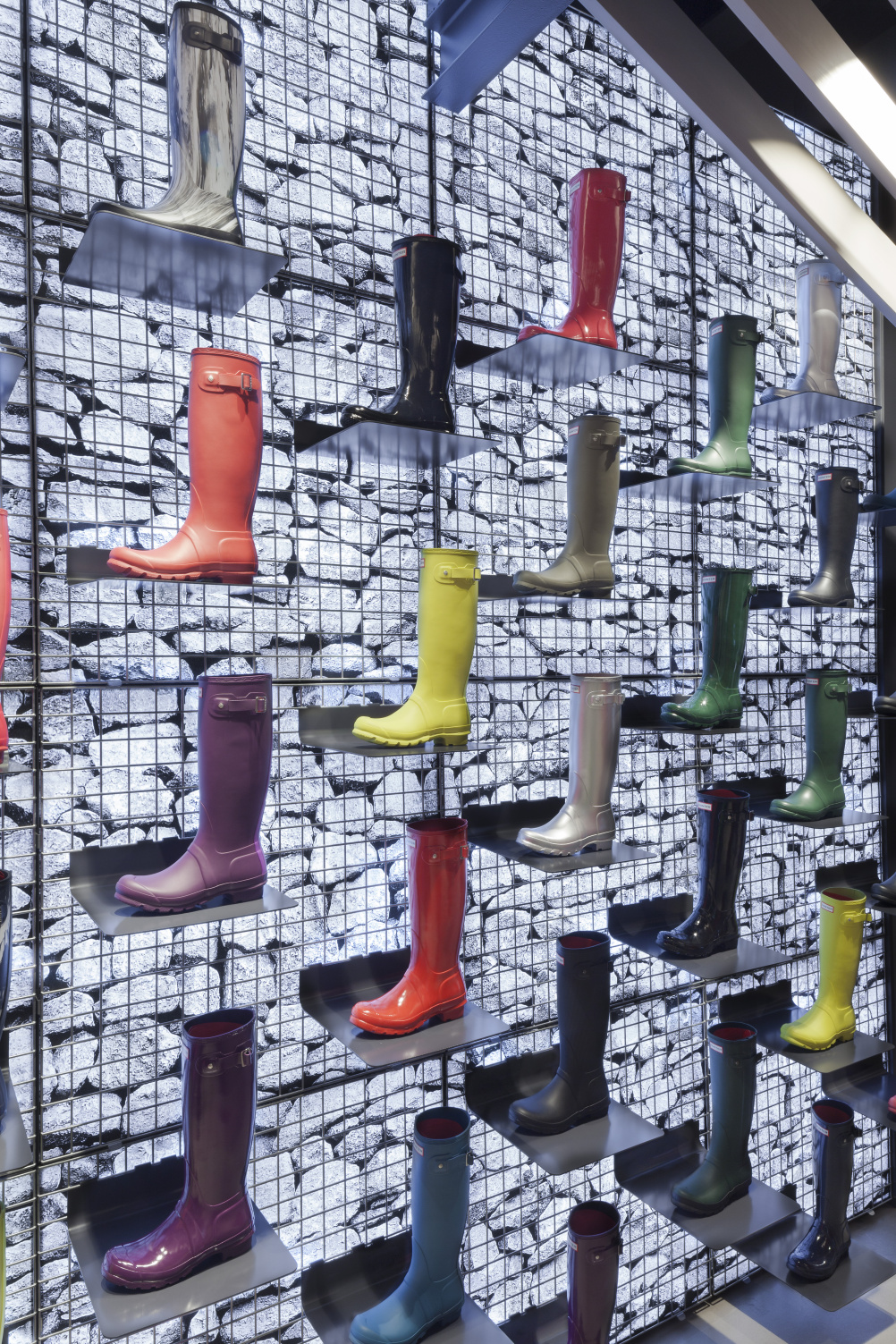 Boots displayed against the gabion wall