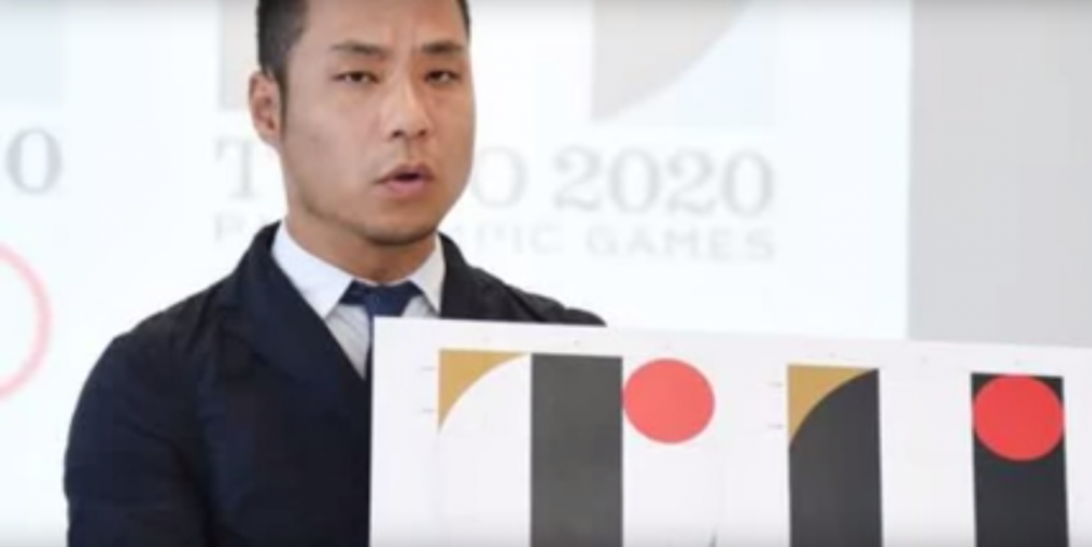 Kenjiro Sano defends his logo in a press conference