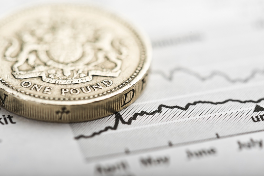 One pound coin on fluctuating graph. Rate of the pound sterling