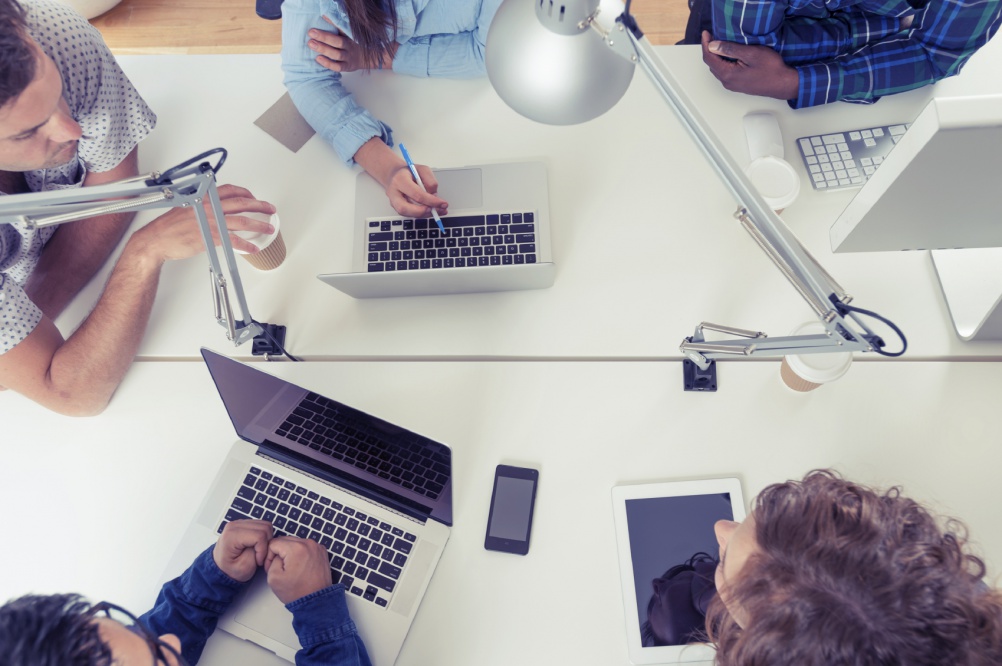 A team of young business people using technology in a meeting