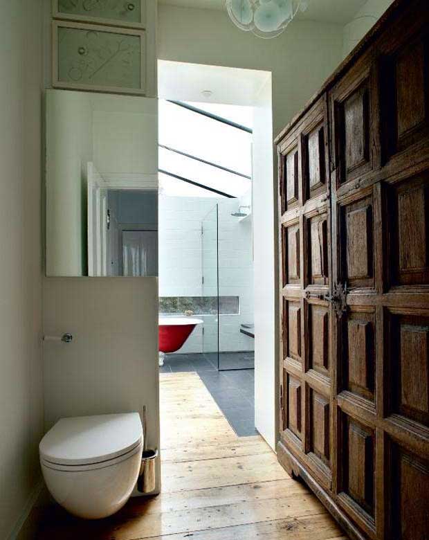 The bathroom includes built-in cupboards