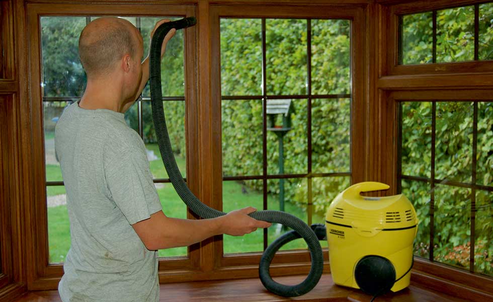 vacuum cleaning around the window frame