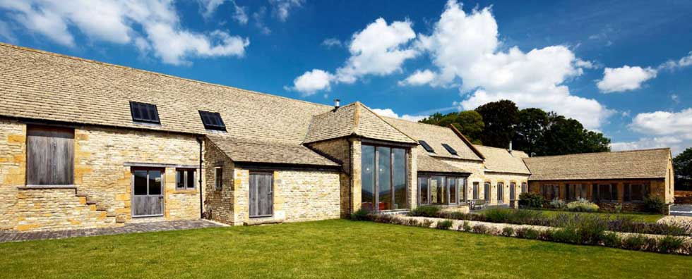 A converted stone barn with large aspect glazing