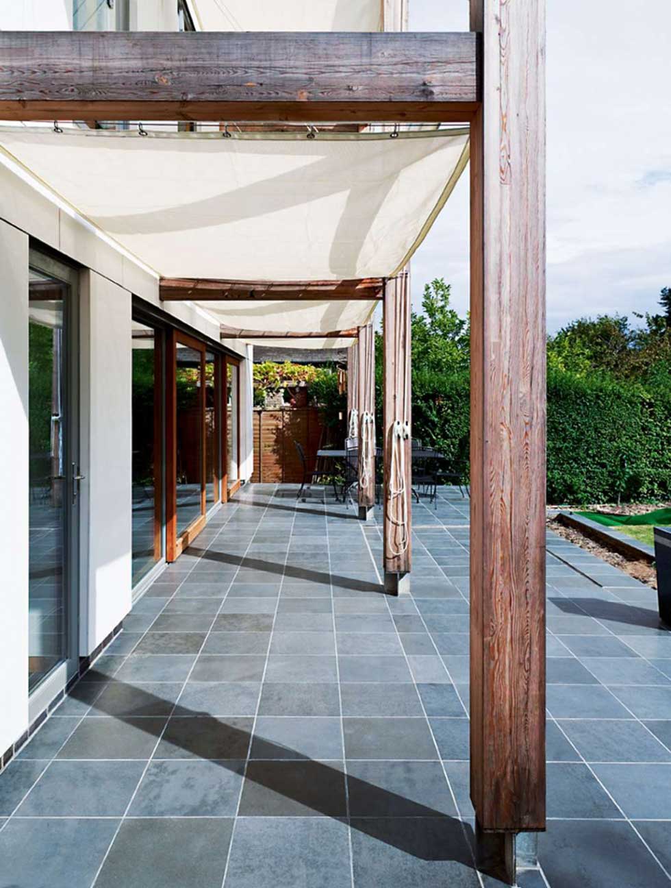 Ceramic slate-look tiles continue out onto the patio and absorb the sun's heat