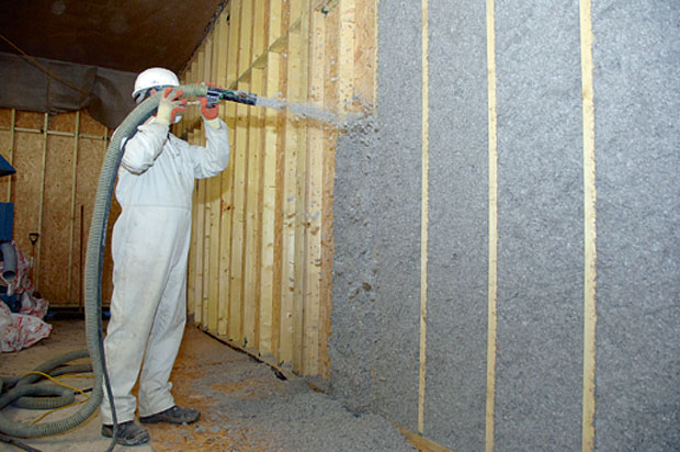 Warmcell being wet-blown into a wall cavity